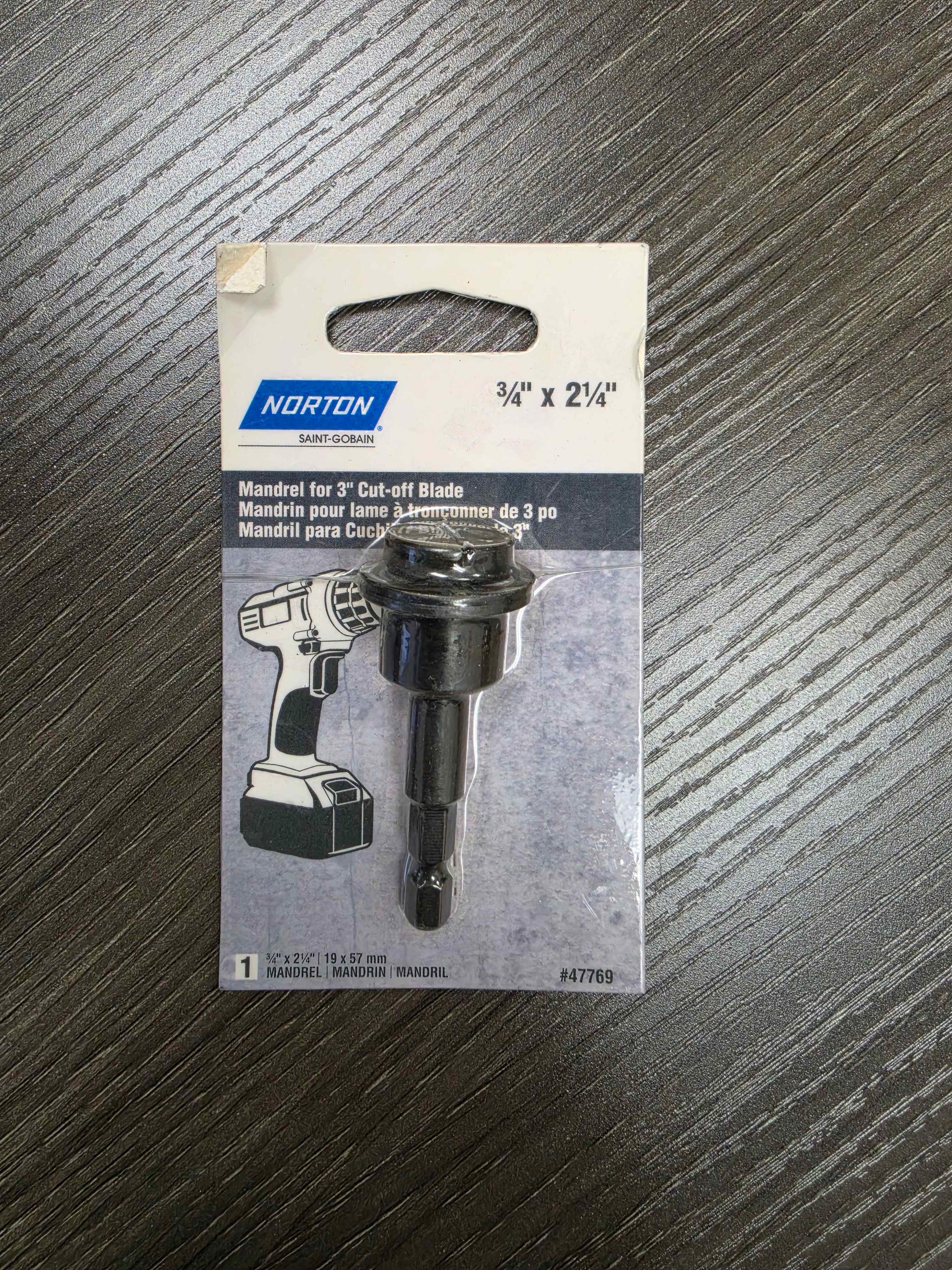 Norton mandrel for 3/4 inch cut-off blade packaging on a wooden surface