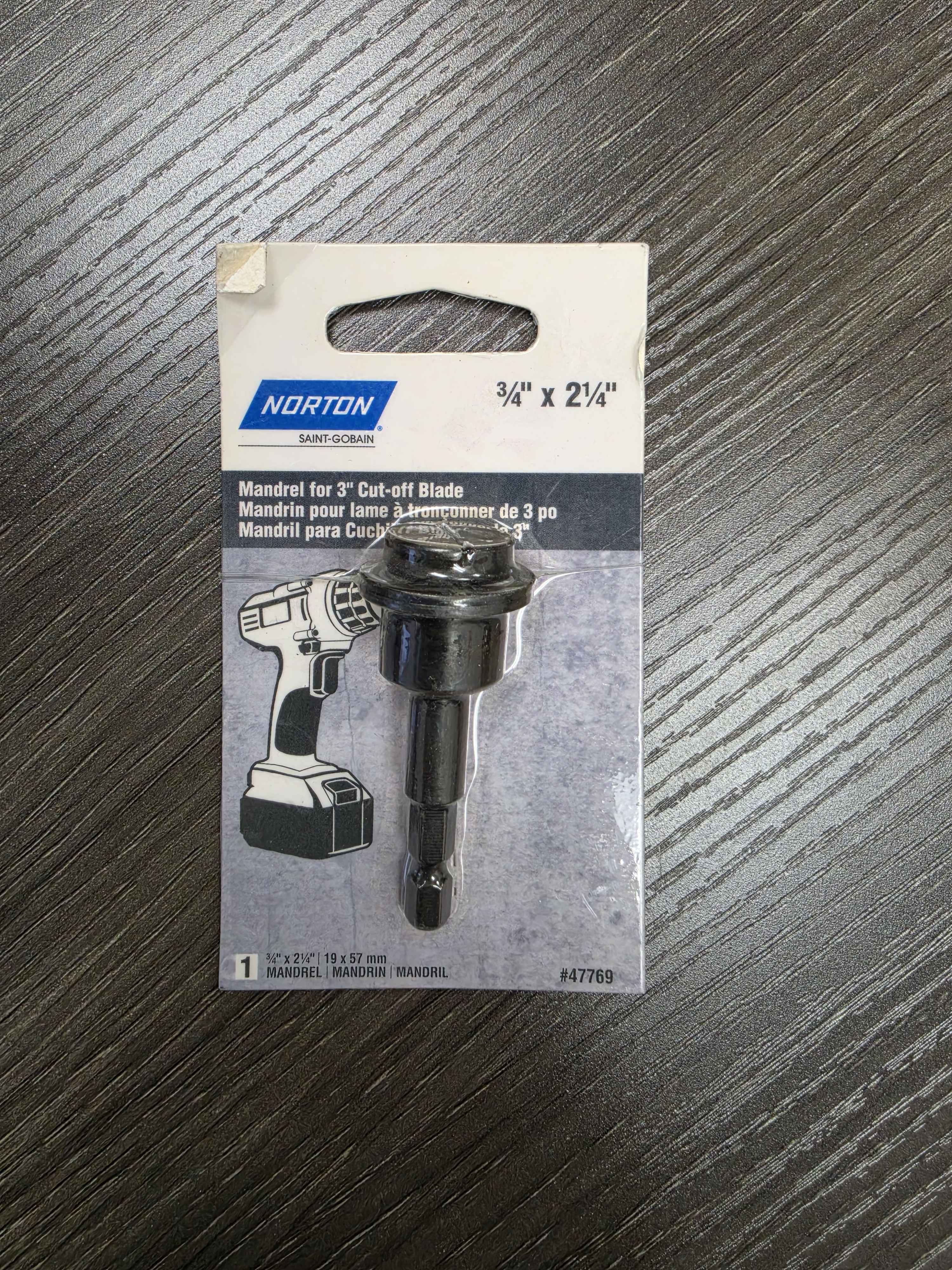 Norton mandrel for 3/4 inch cut-off blade packaging on a wooden surface