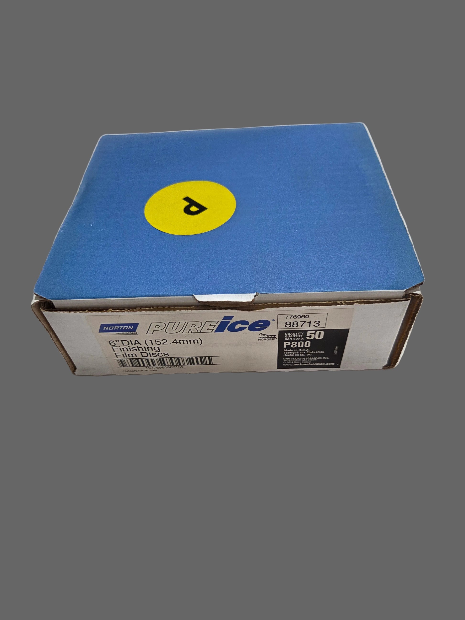 Blue box with a yellow logo on a white surface