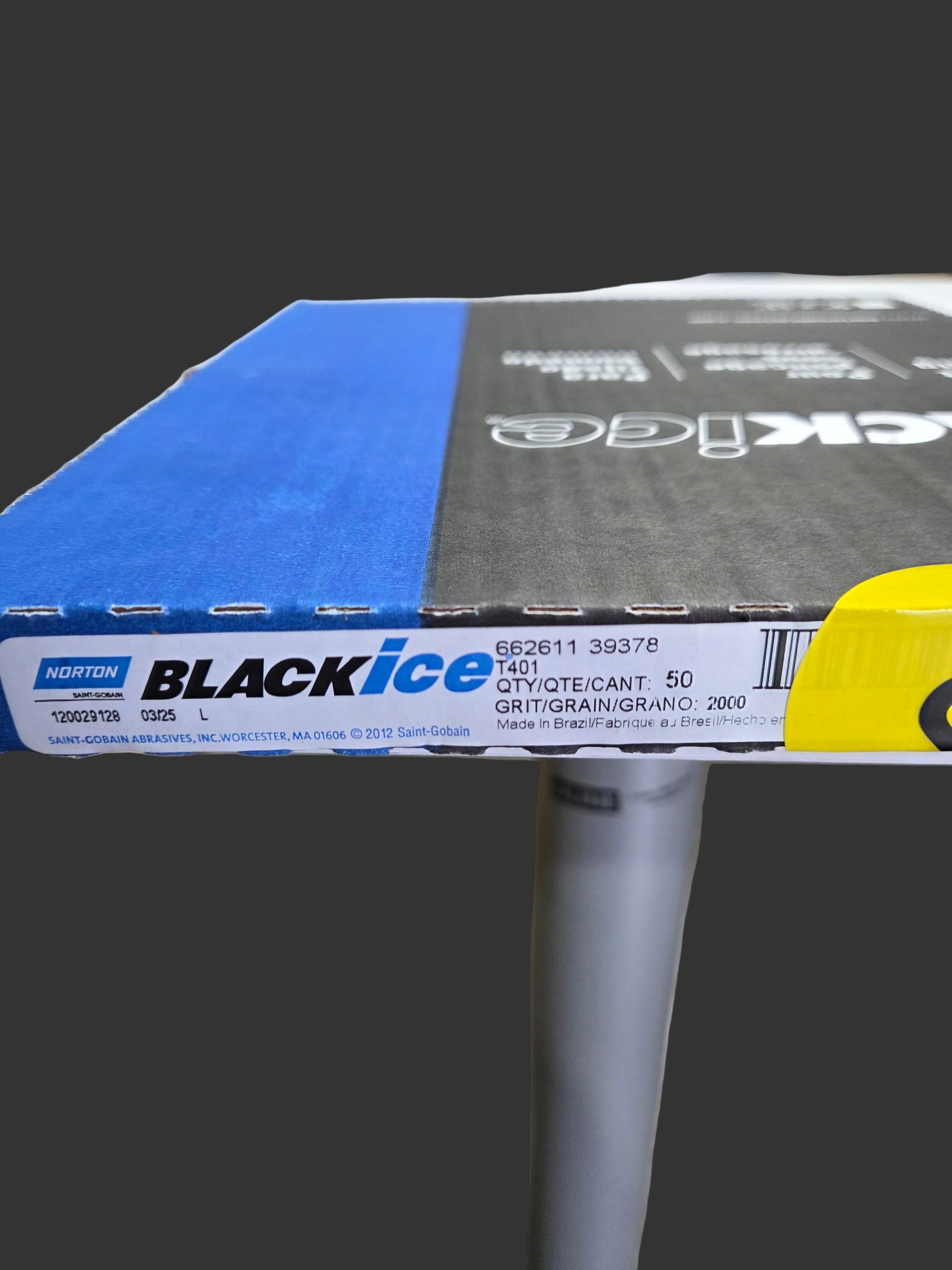 Close-up of a Black Ice product with a blurred warehouse background