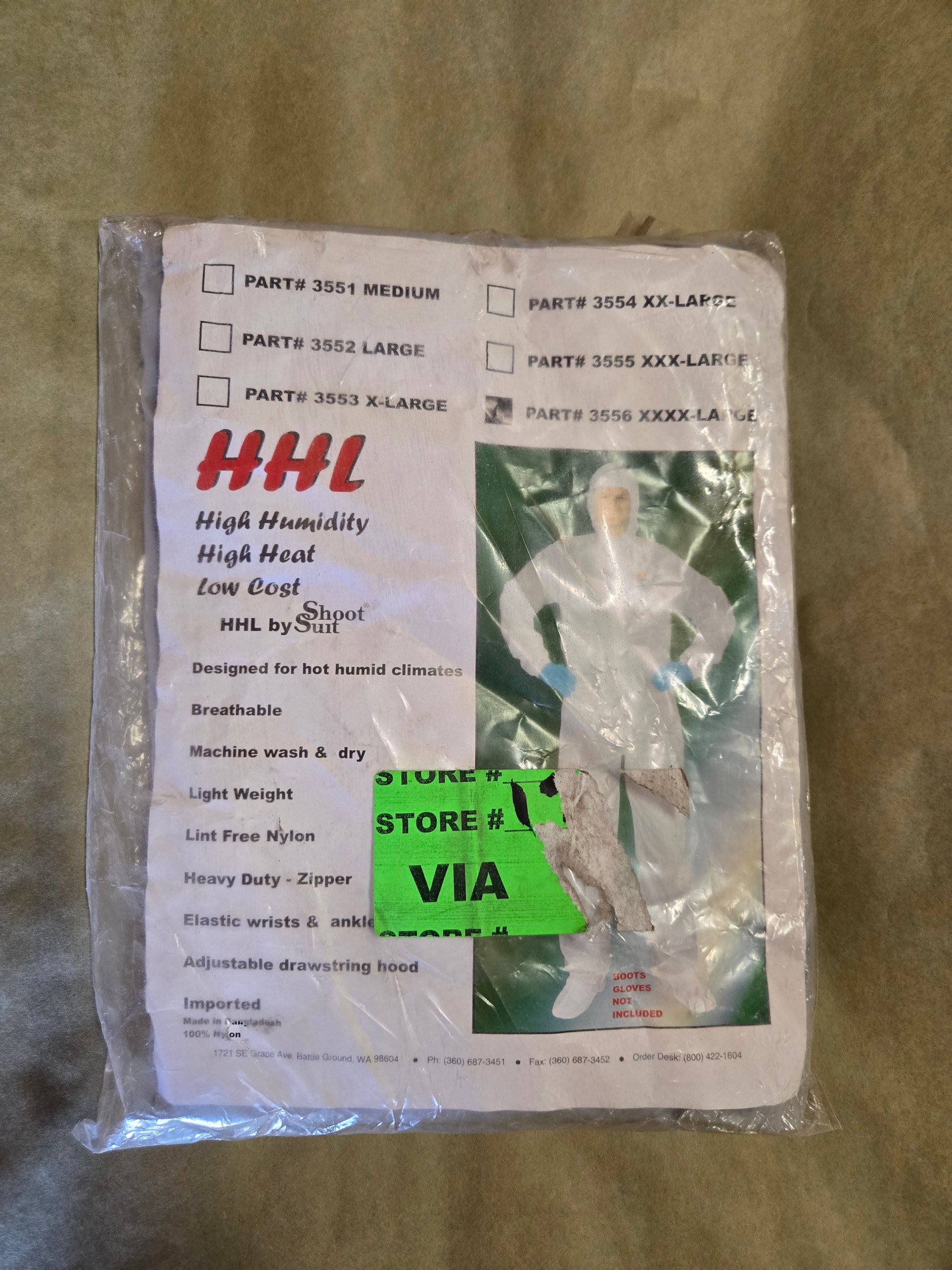 Packaged suit with HHL label on a textured surface