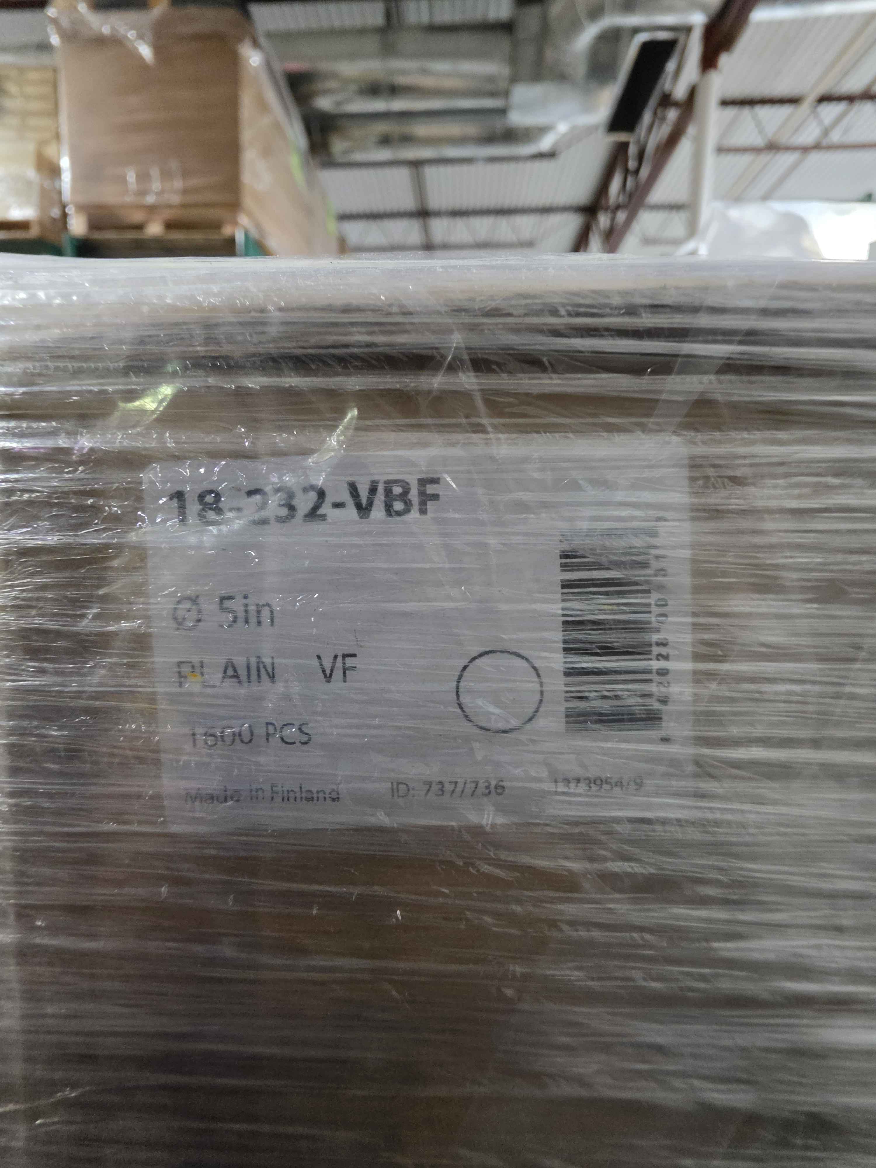 Stack of cardboard boxes with a label on a warehouse floor