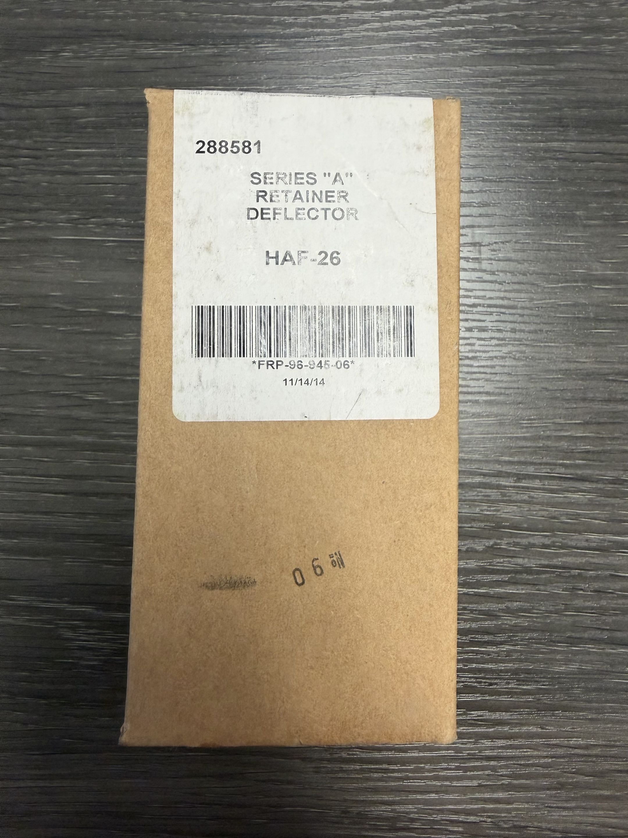 Brown box with a label on a dark wooden surface