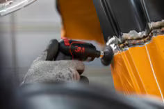 Close-up of a chainsaw in action with a blurred background