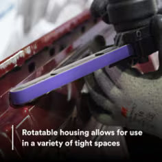 Hand holding a tool with rotatable housing in a close-up shot