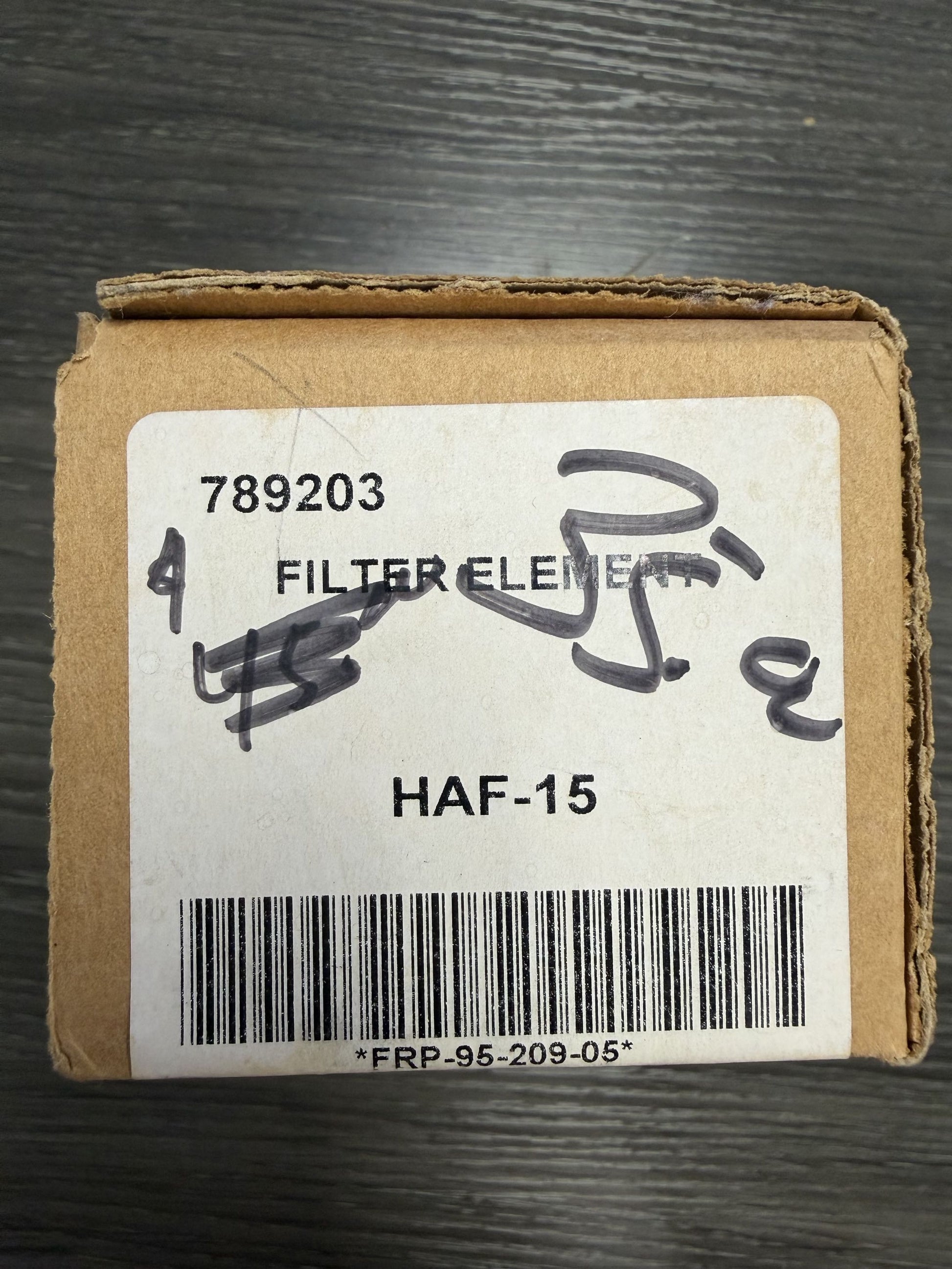 Cardboard box with a label on a dark surface