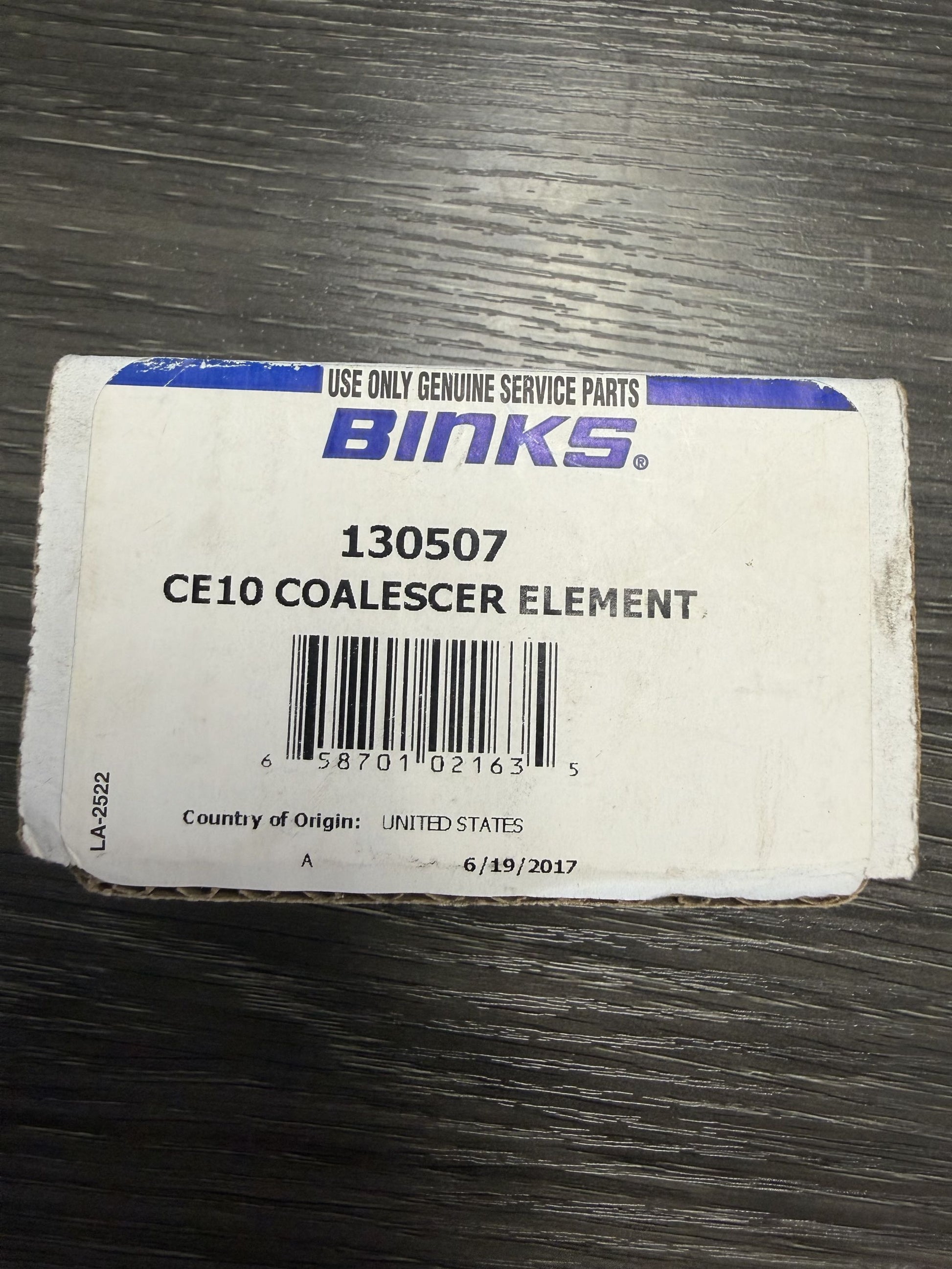 Binks CE10 Coalescer Element packaging on a wooden surface