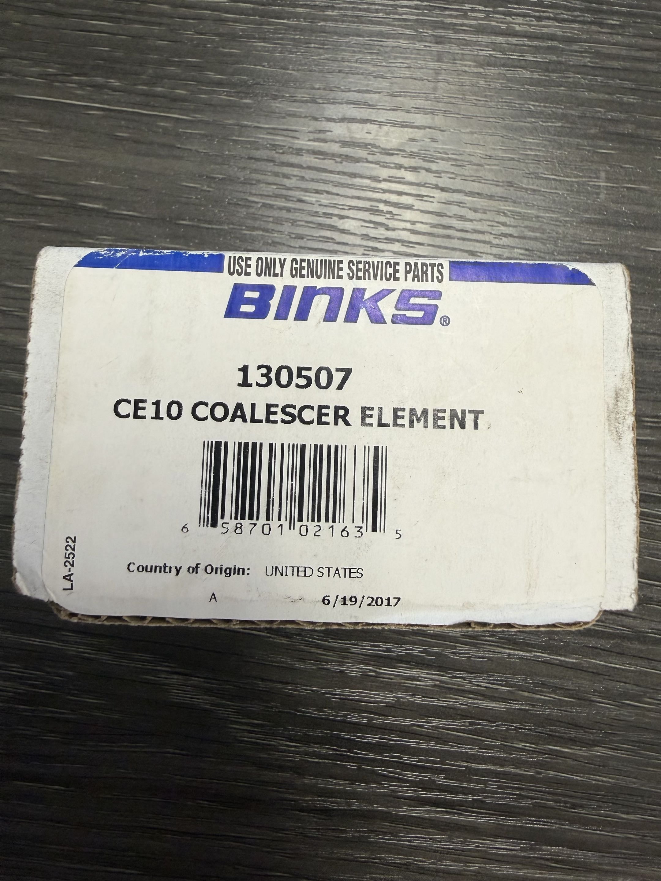Binks CE10 Coalescer Element packaging on a wooden surface