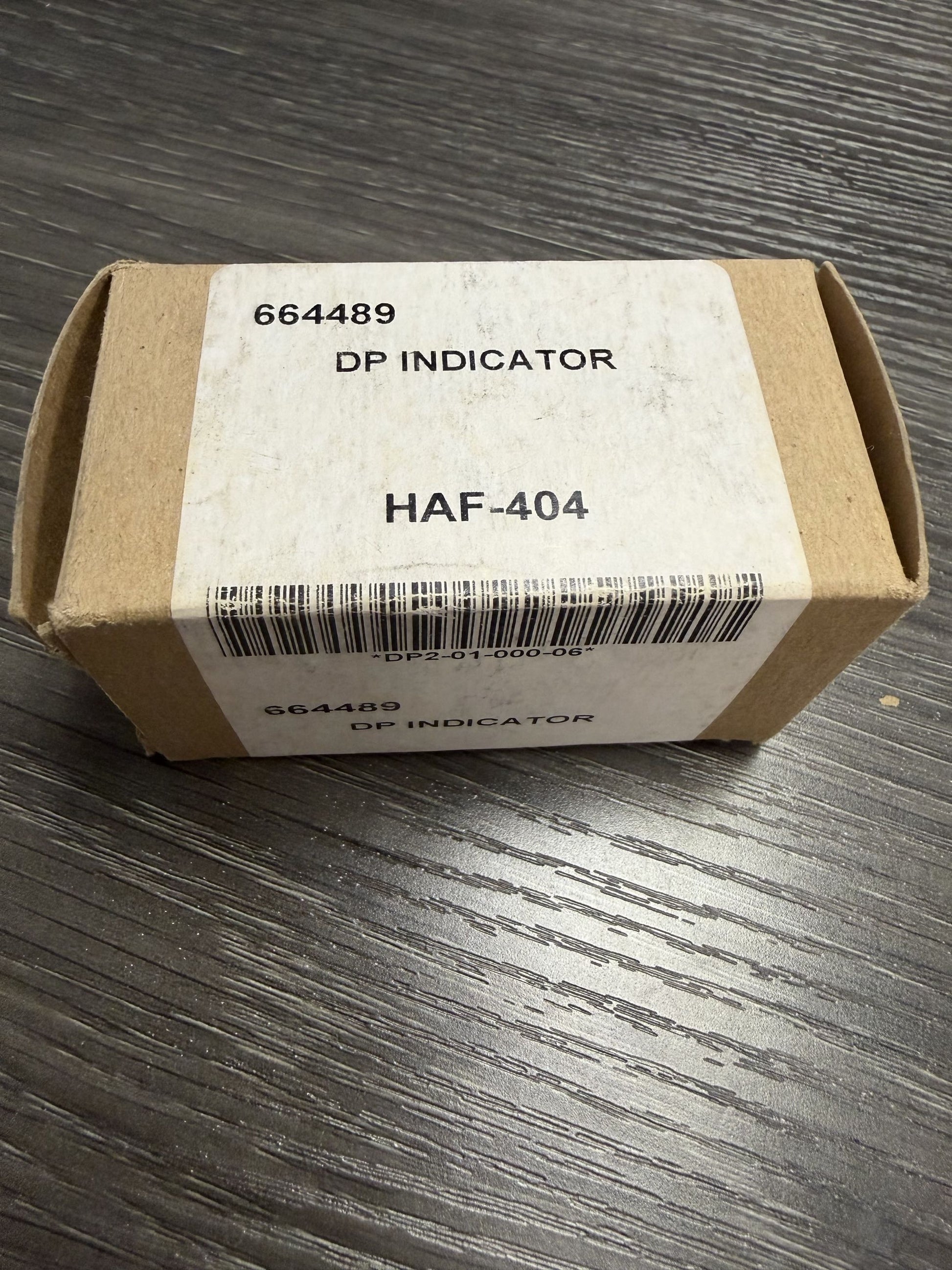 Cardboard box with a label on a wooden surface