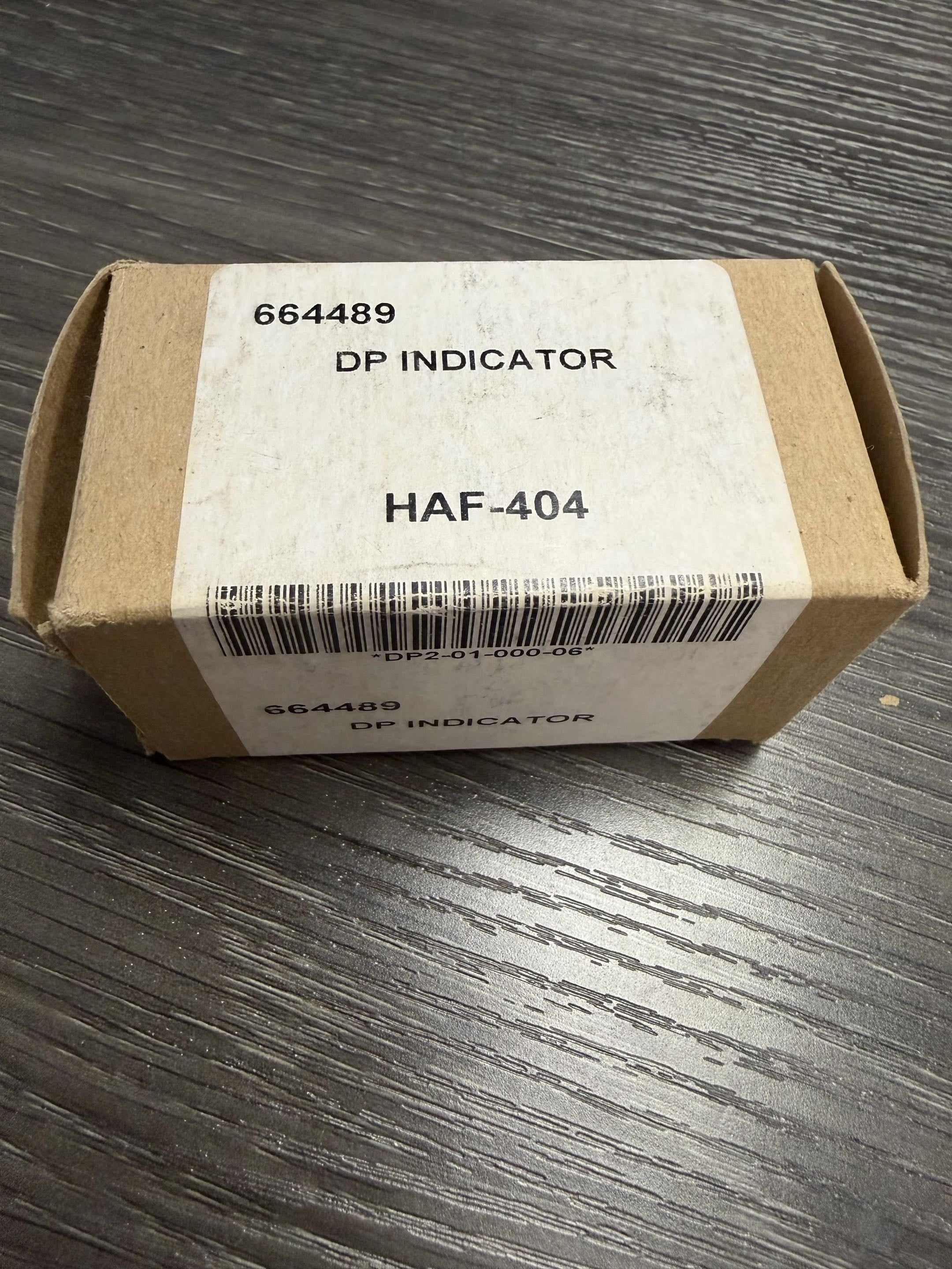 Cardboard box with a label on a wooden surface