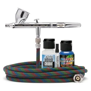 Airbrush kit with hose and cleaning solution bottles on a white background