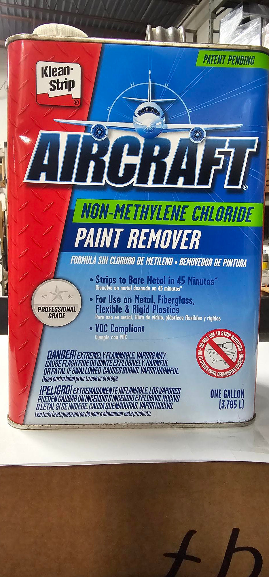 AirCraft paint remover container with blue and red design on a cardboard background