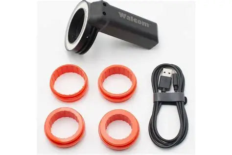 Wacom digital pen setup with pen, four red rings, and USB cable on a white background