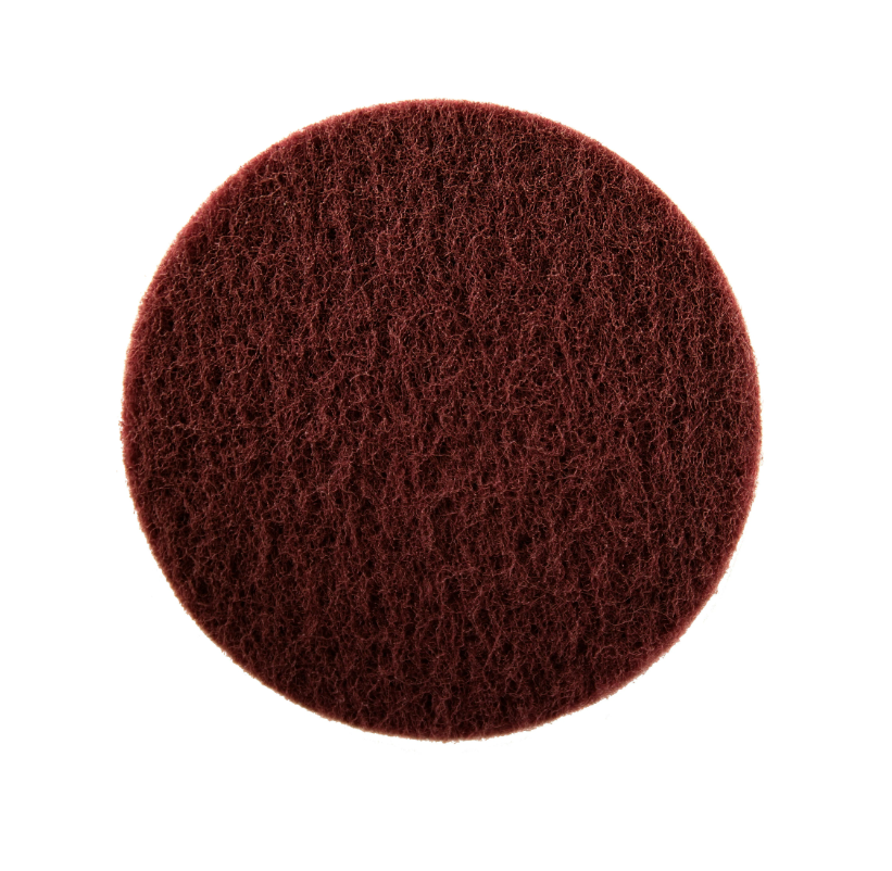 Round brown scrubber pad on a white background