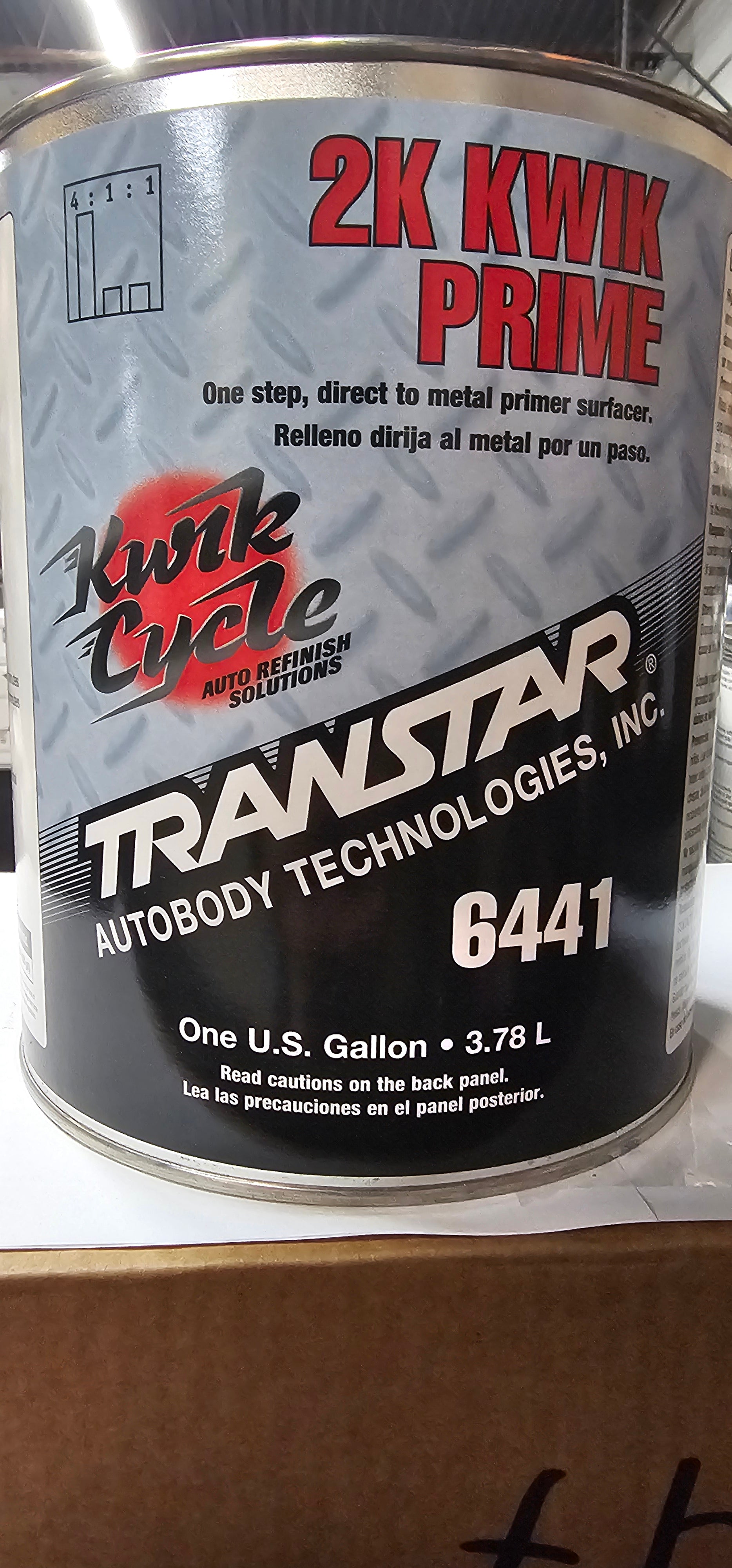 Can of 2K Kwik Prime with Transstar Technologies branding on a cardboard background