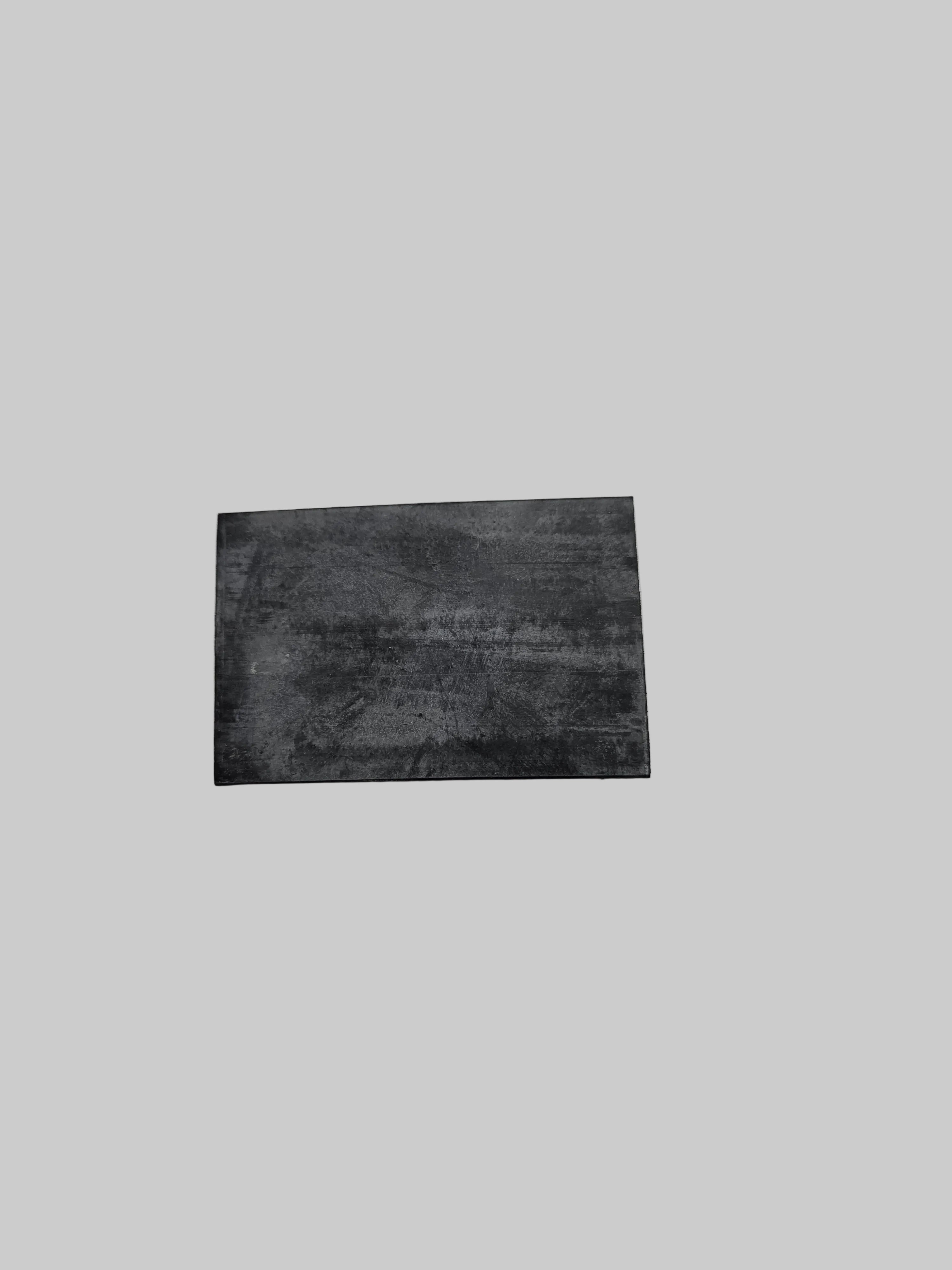 Rectangular black leather patch on a light gray background