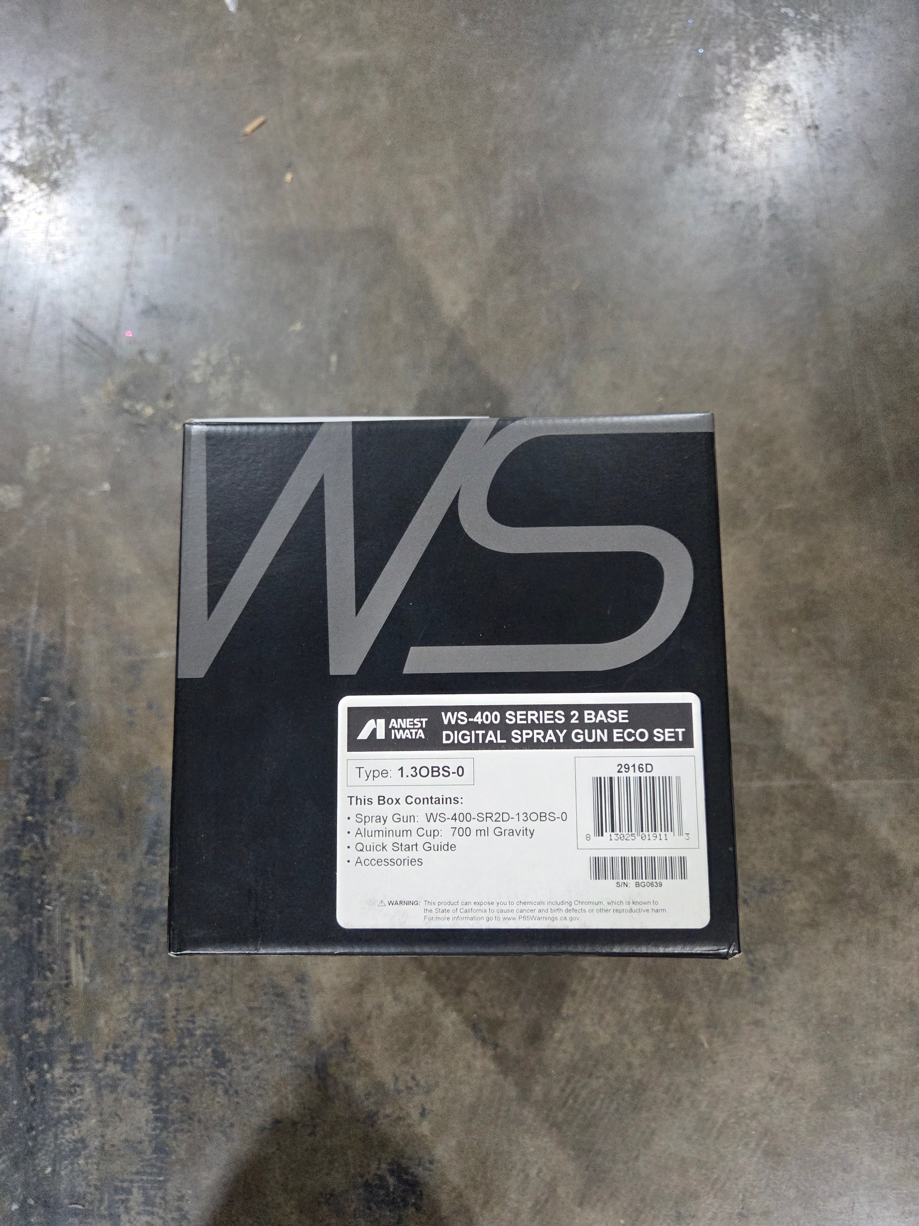 Black box with a brand logo on a metallic surface