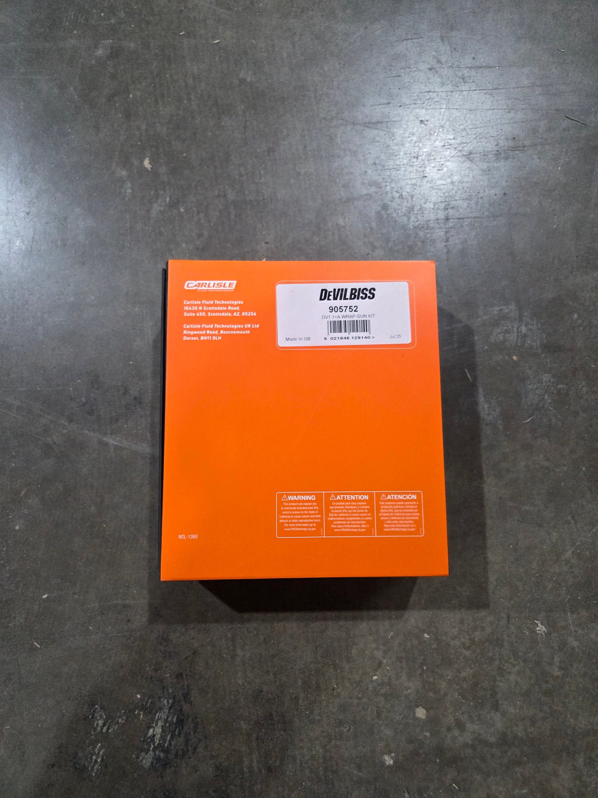 Orange box with a label on a dark gray surface