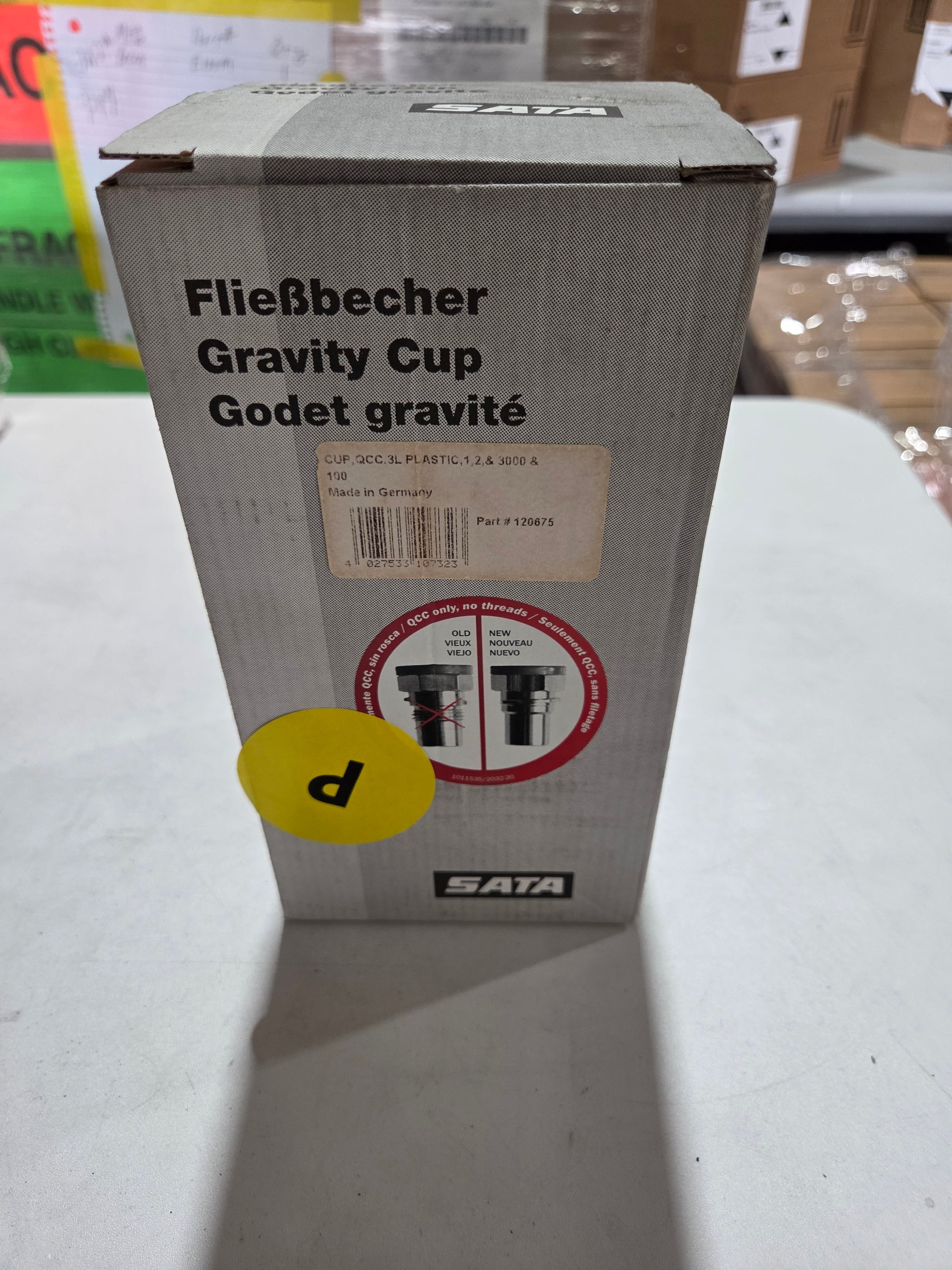 Cardboard box with labels and text on a white surface