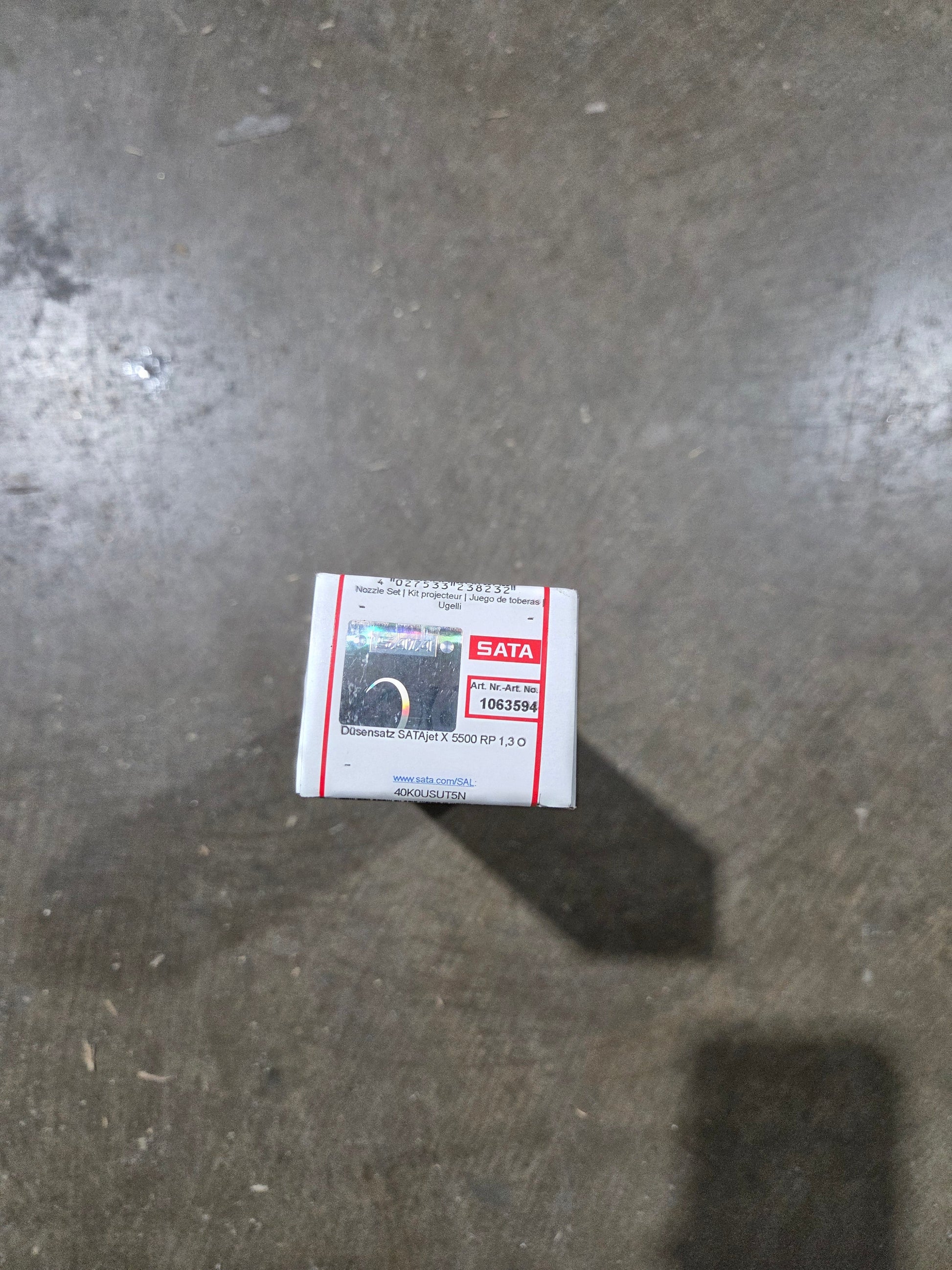 Small box with a label on a concrete floor