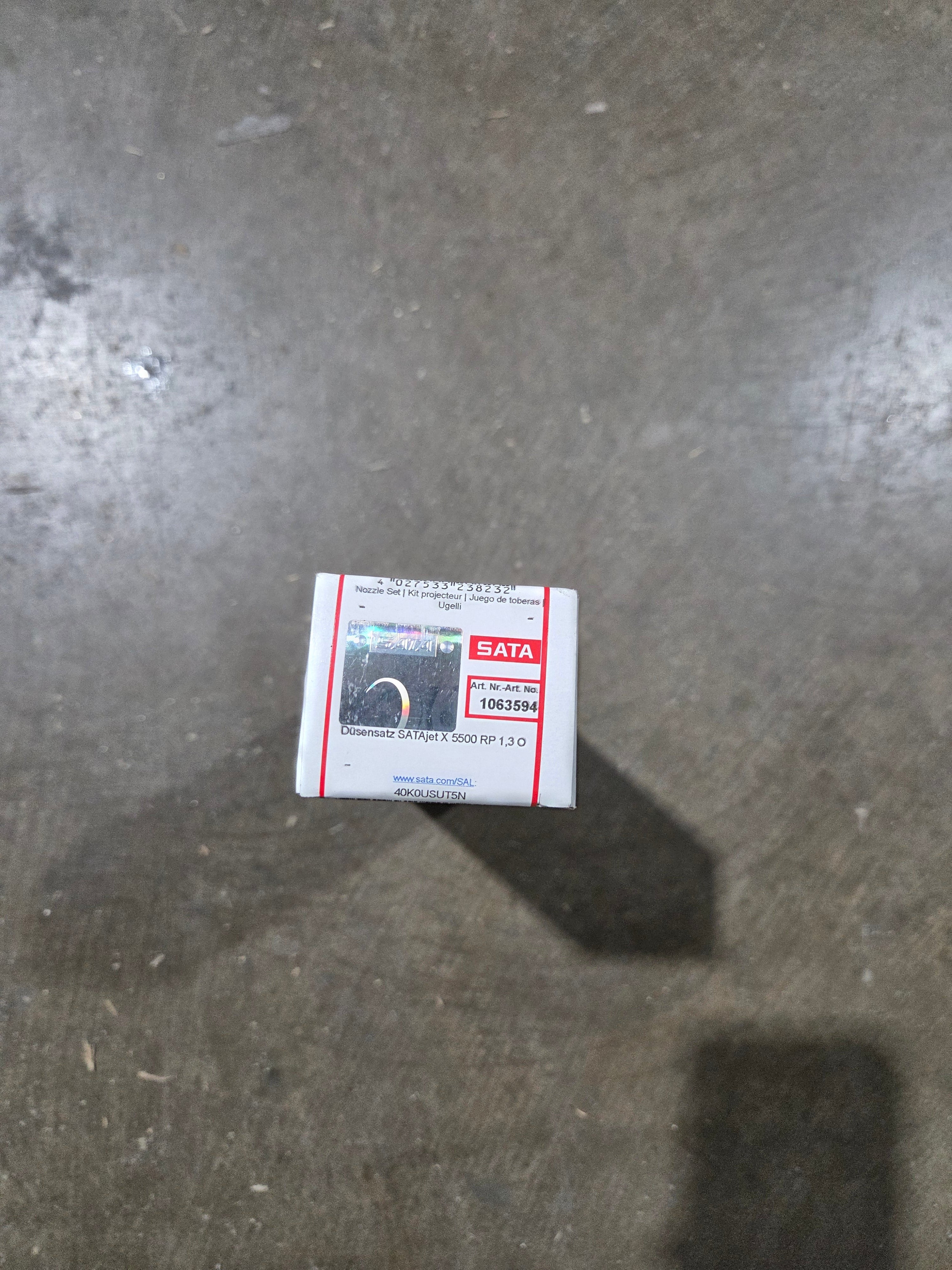 Small box with a label on a concrete floor