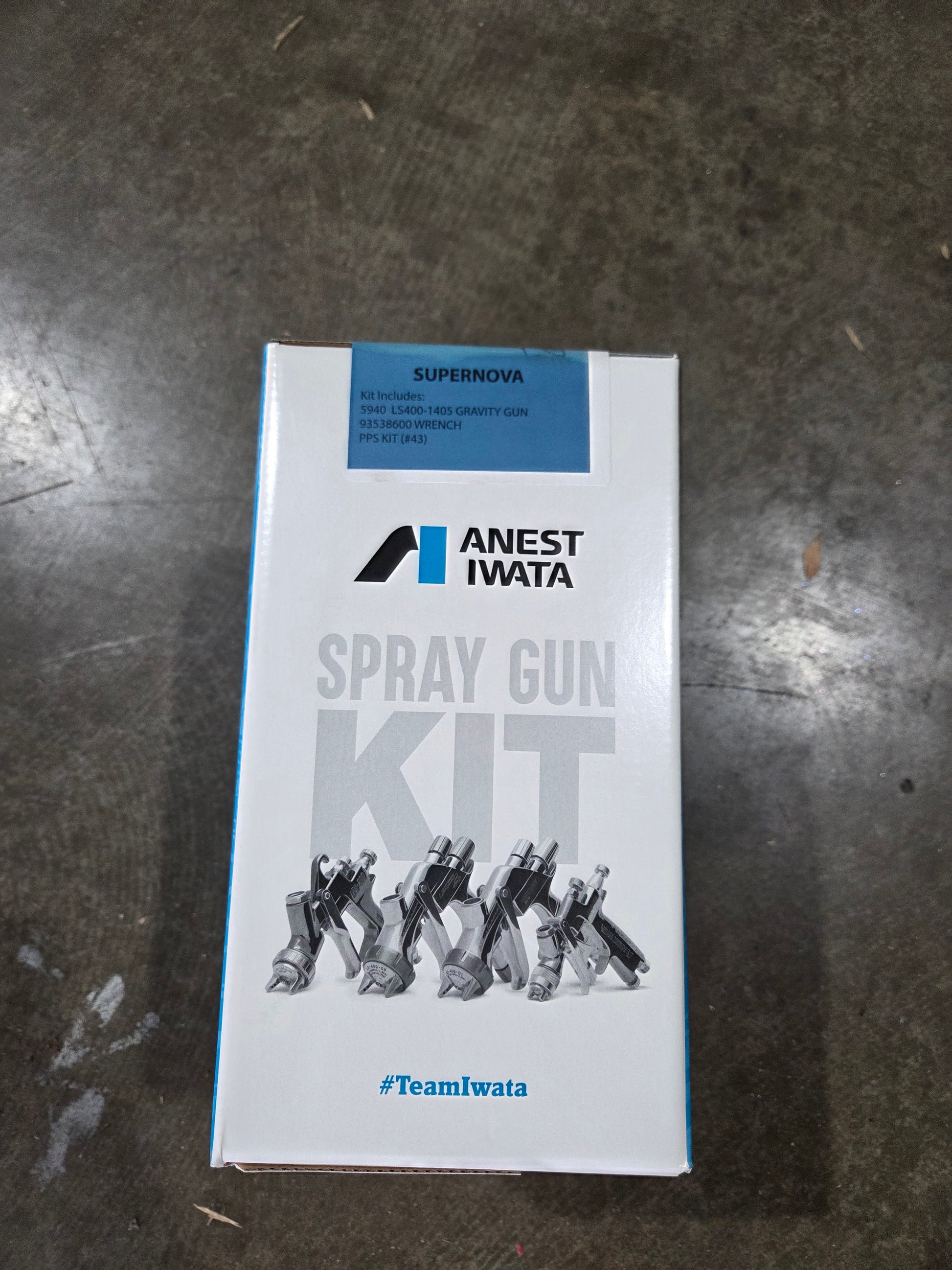 Anest Iwata spray gun kit packaging on a dark surface