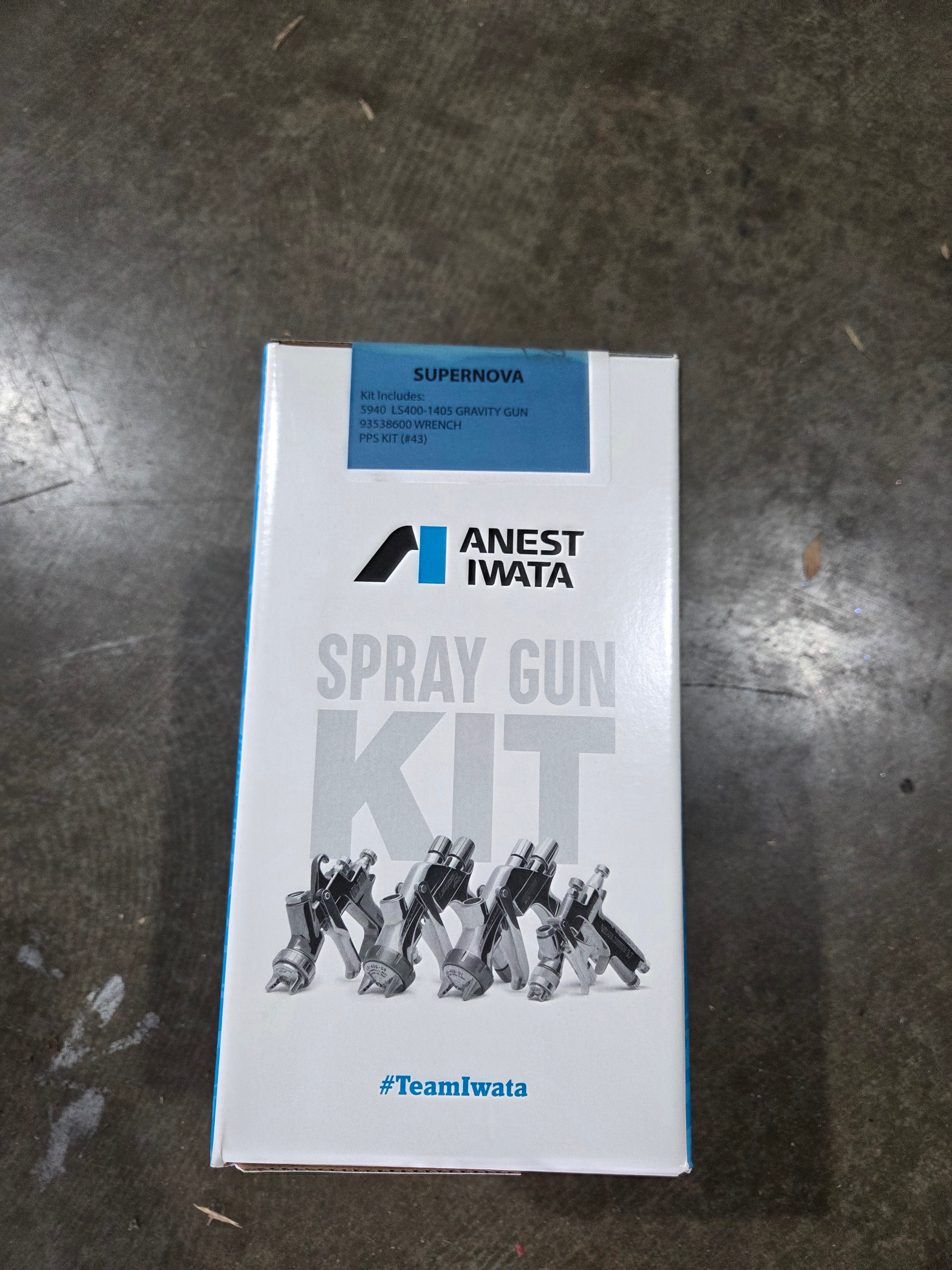 Anest Iwata spray gun kit packaging on a dark surface