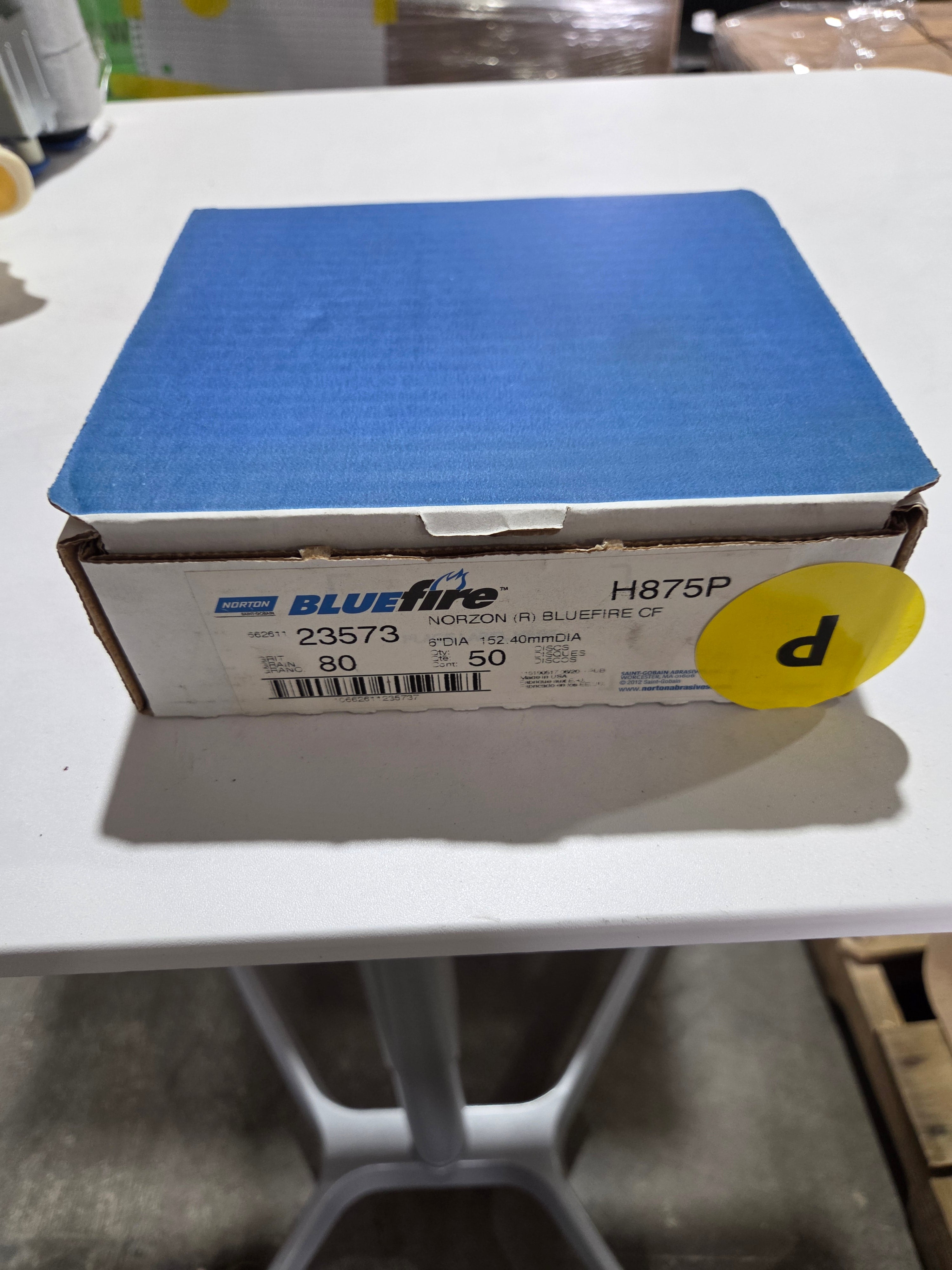 Blue box with a yellow label on a white surface