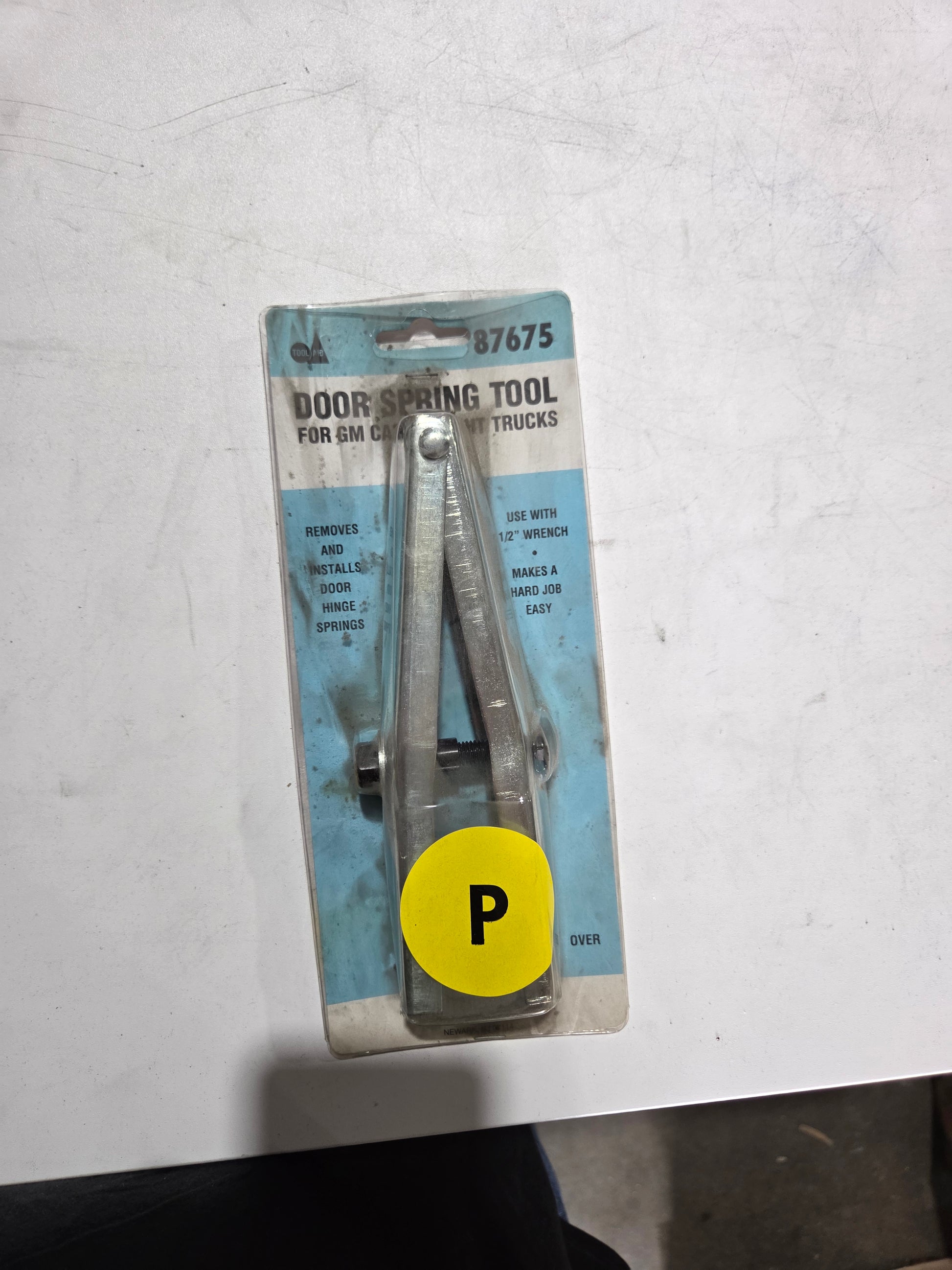 Door spring tool on a white background with a yellow 'P' label