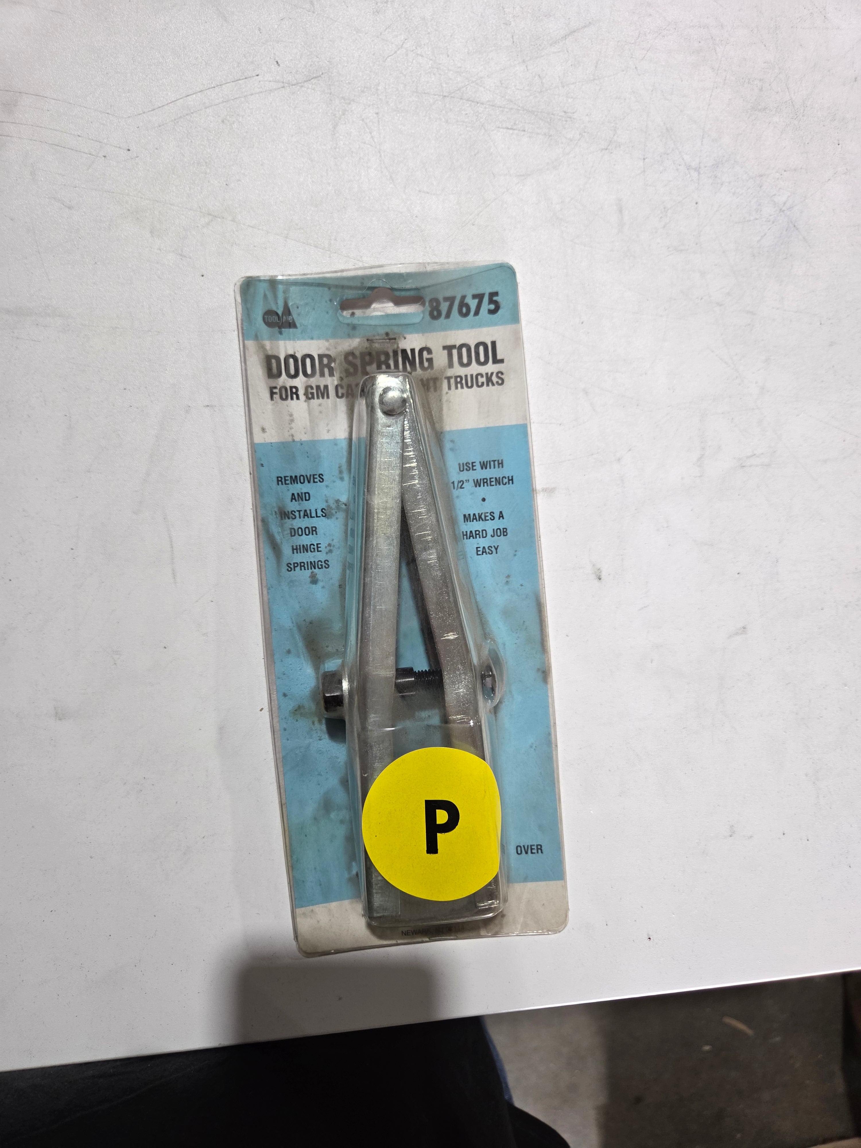 Door spring tool on a white background with a yellow 'P' label