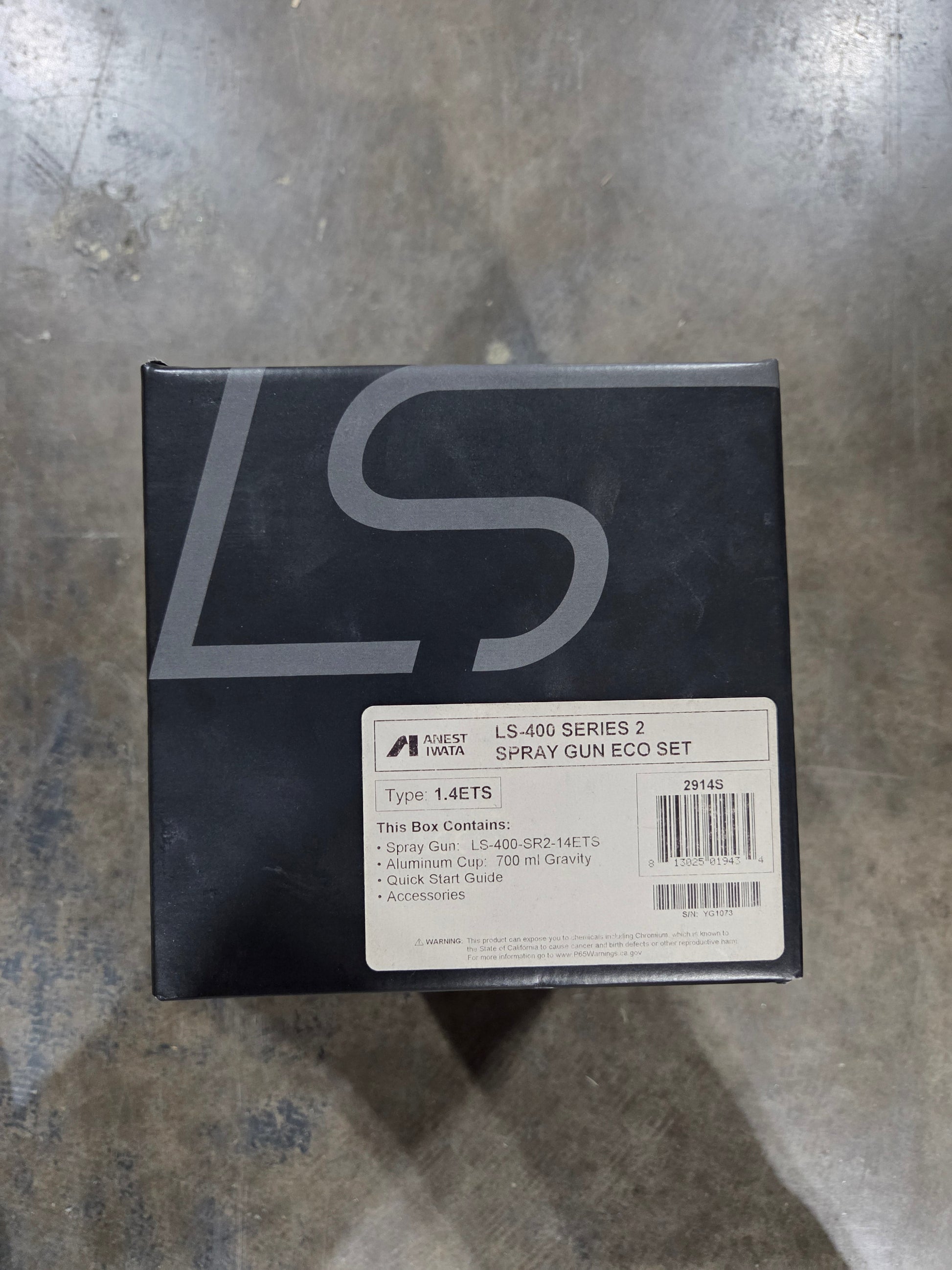 Black box with 'S' logo on a gray surface