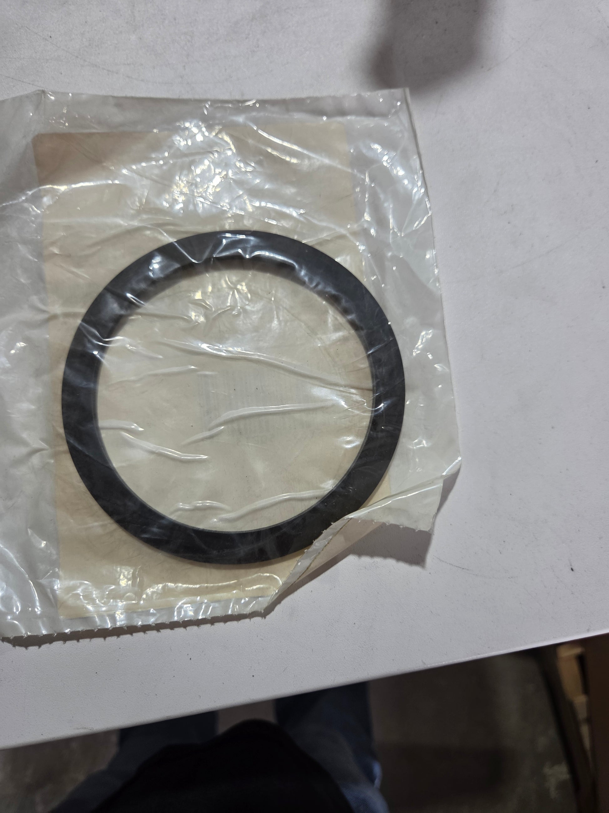 Black rubber gasket on a white background