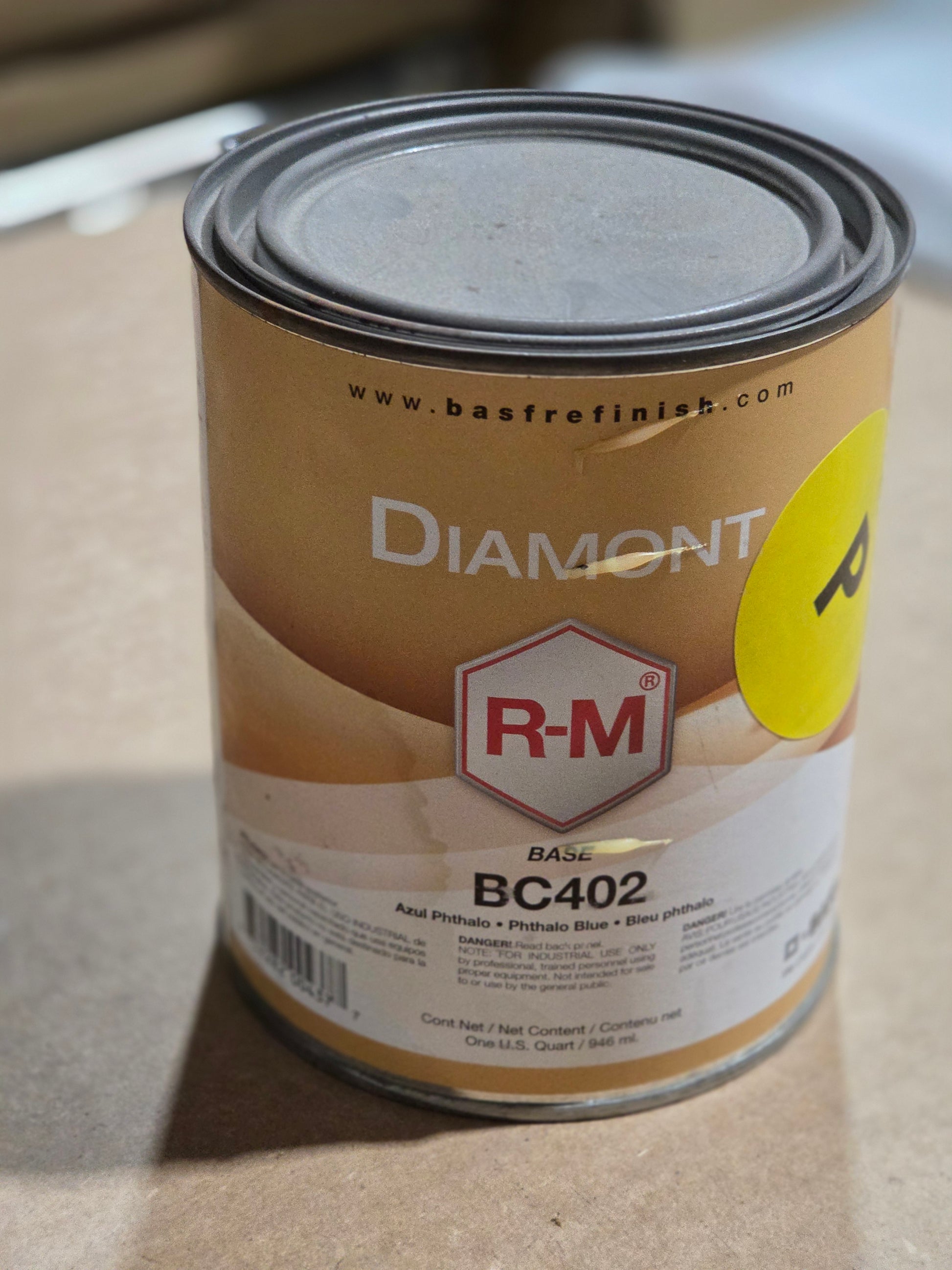 Can of R-M Diamondit BC402 paint on a cardboard surface