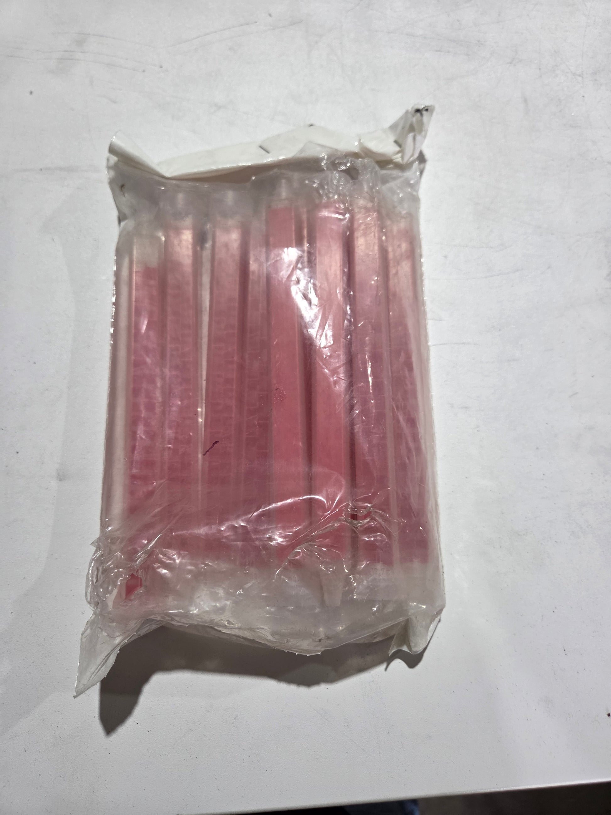 Packaged pink sticks on a white background