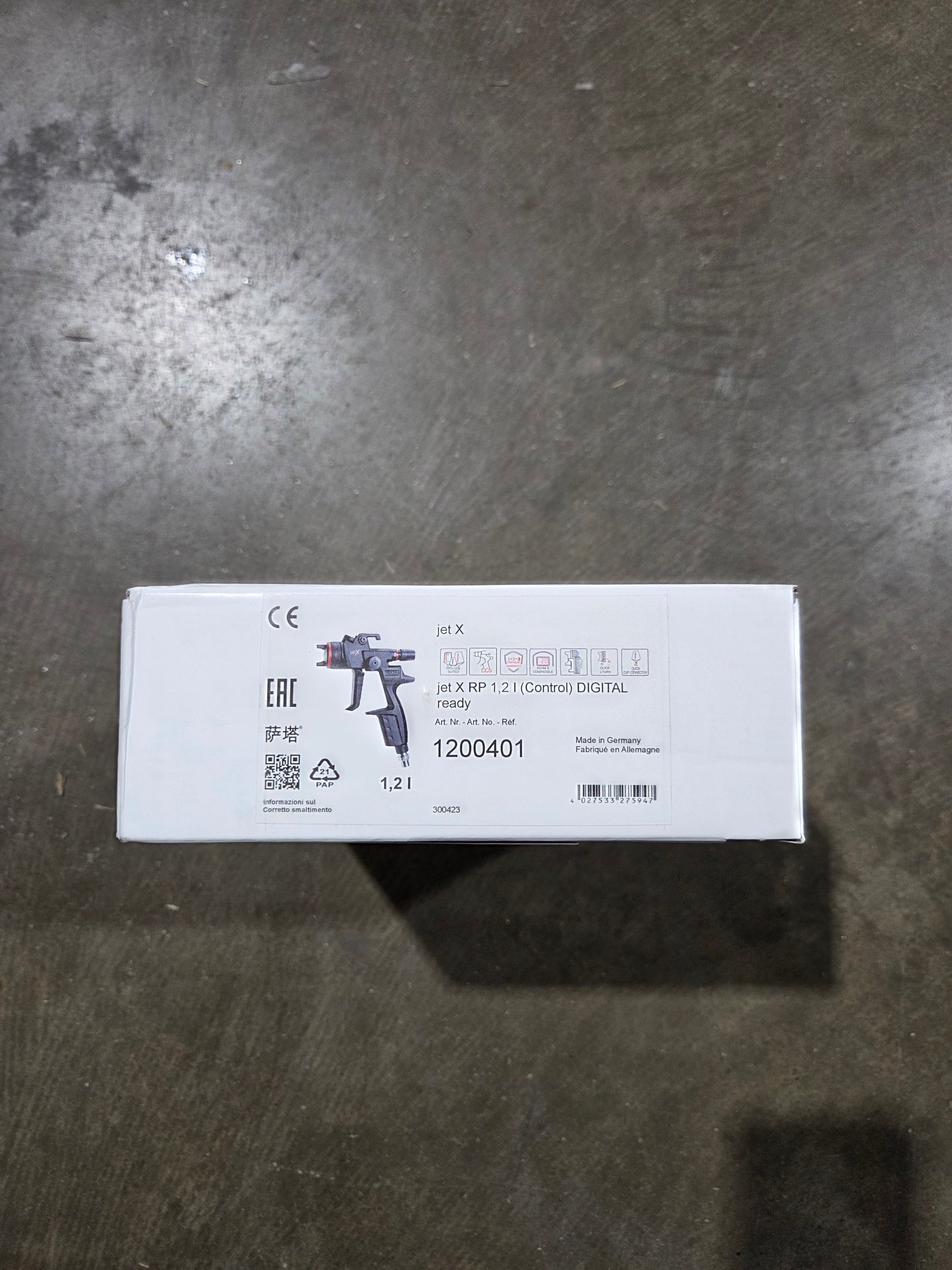 White box with text and a gun illustration on a dark surface