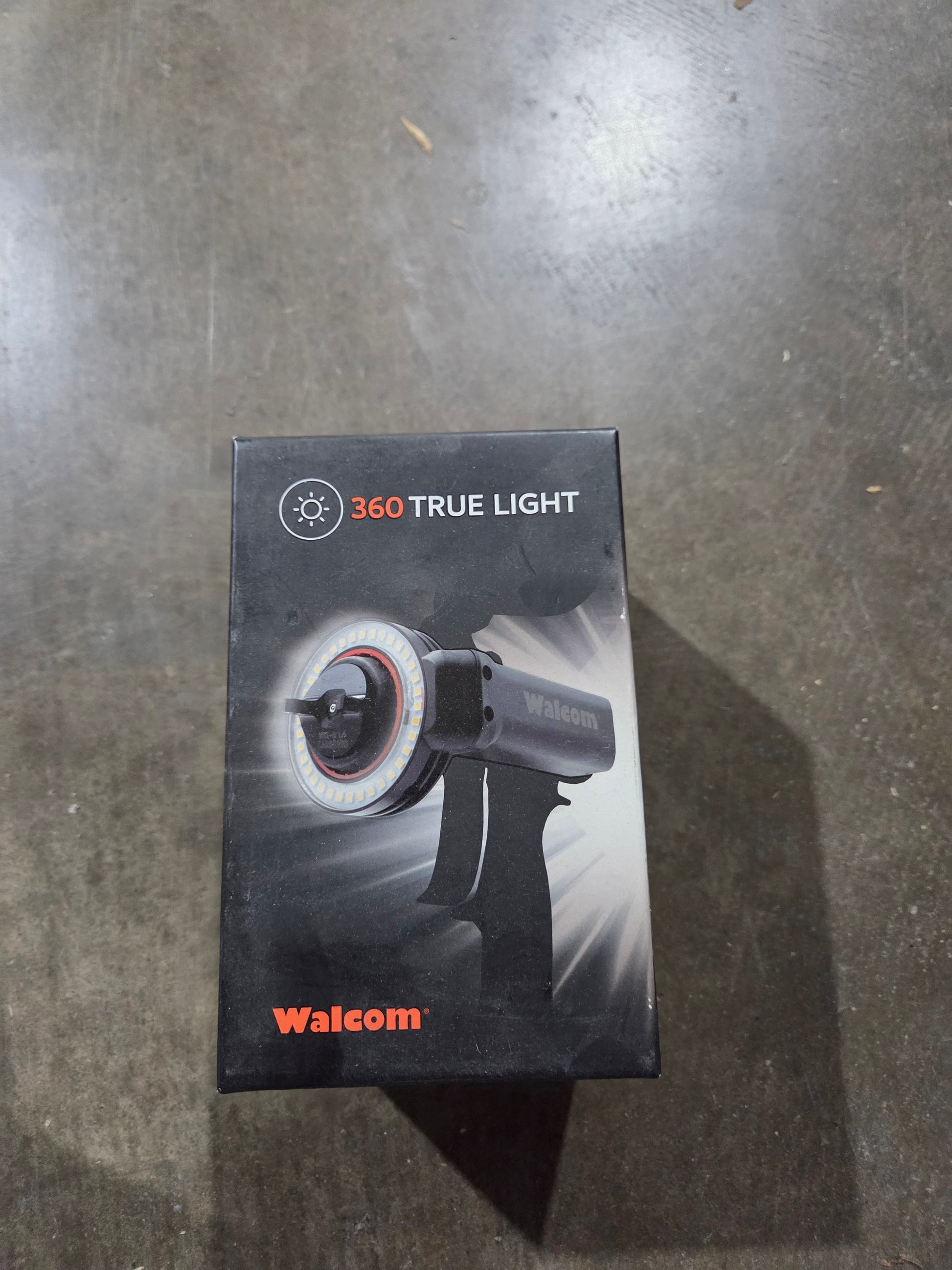 Box of a 360 True Light device with Walcom branding on a gray surface