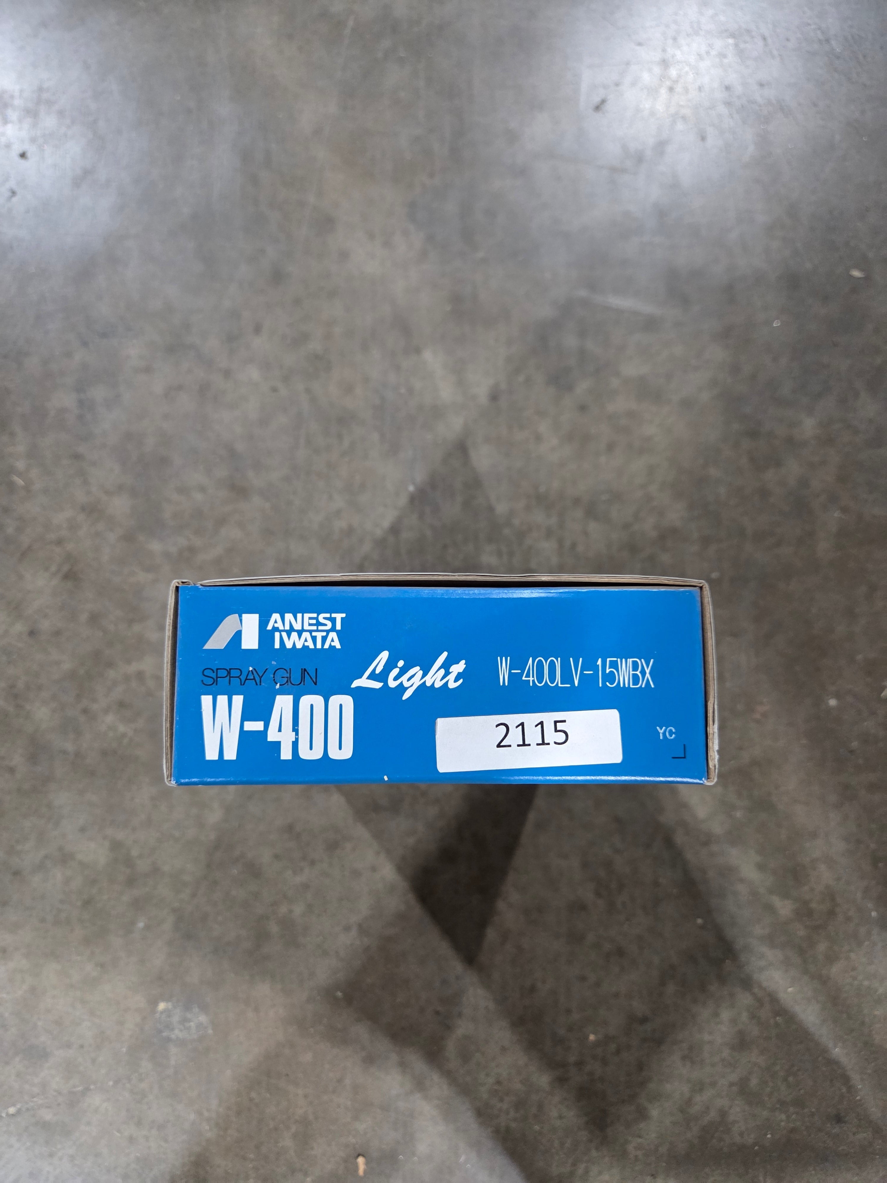 Blue box with white label on a gray concrete floor