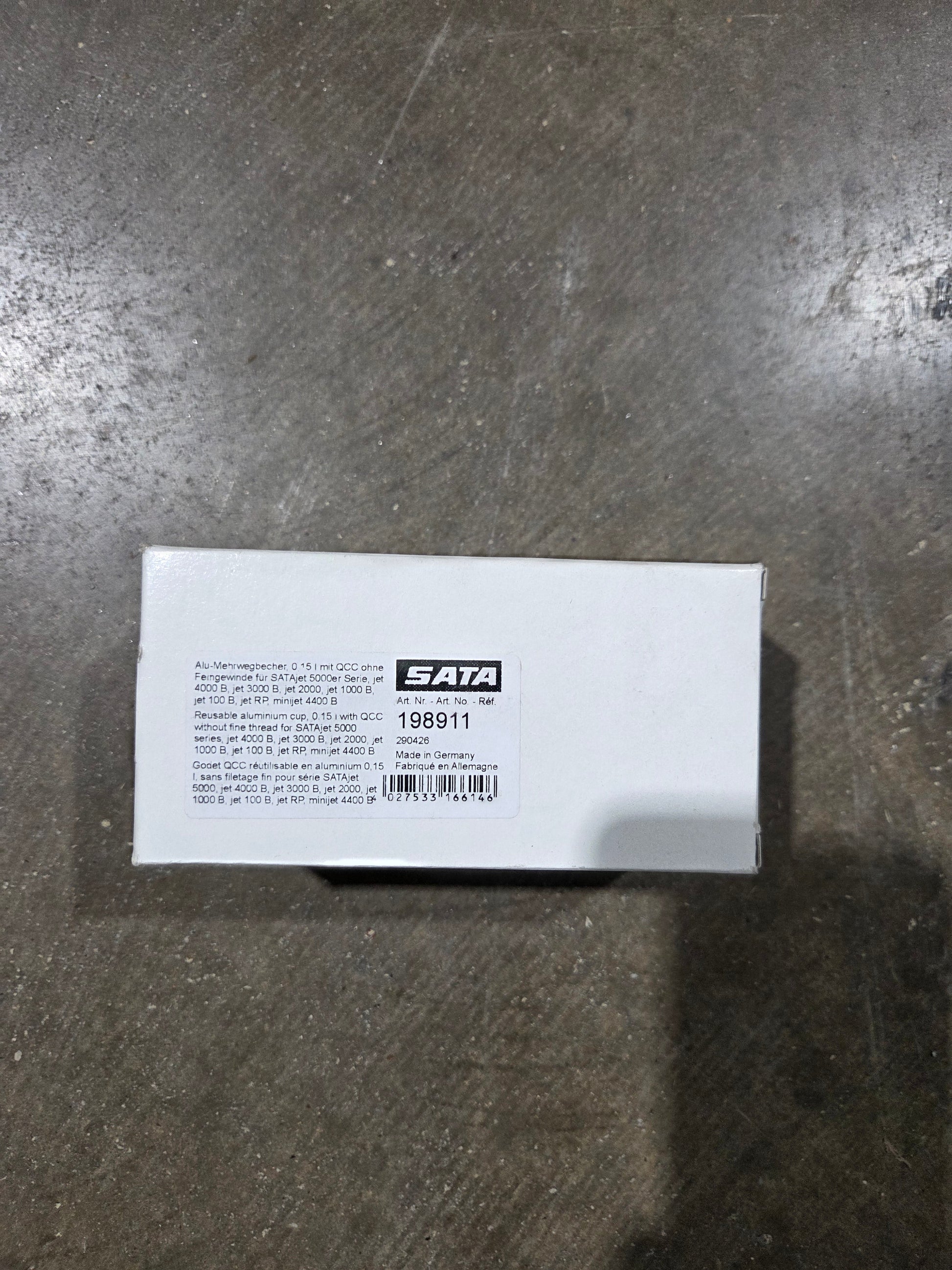 White box with a label on a metallic surface