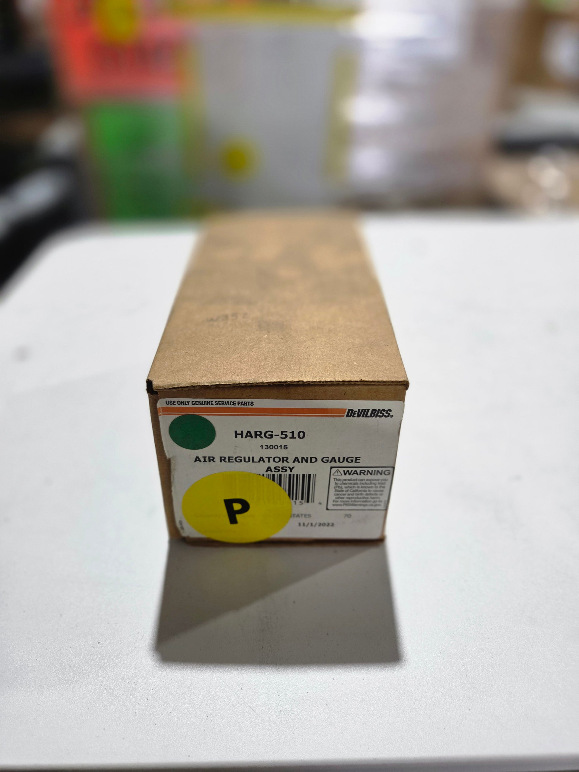 Cardboard box with a yellow label on a white surface
